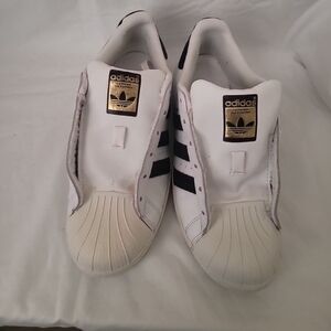 Adidas White Sneakers with Black Stripes and Gold Logo